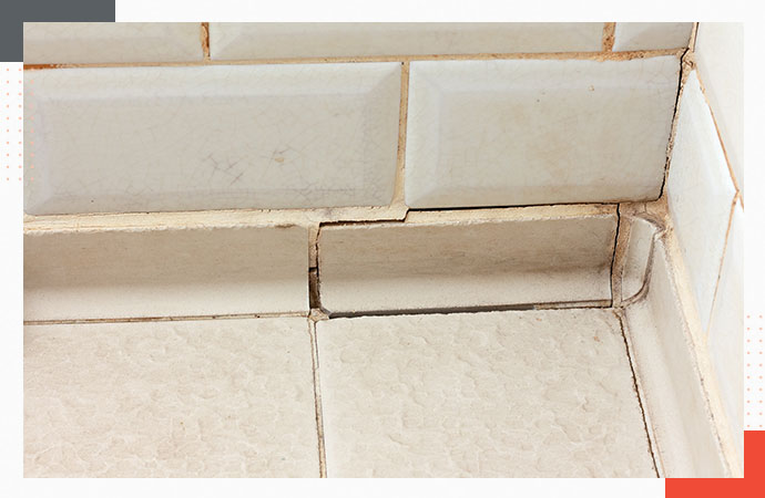 Cracked tile and damaged grout