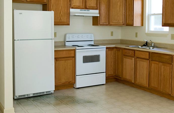 White refrigerator leaking water